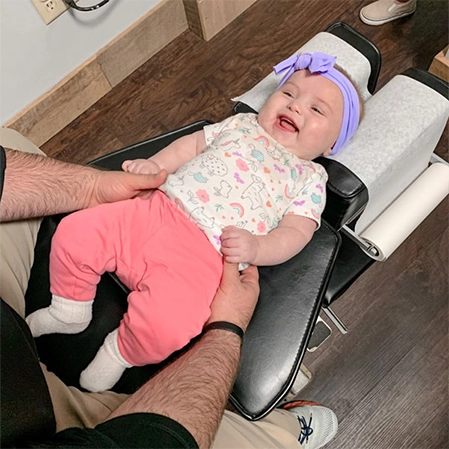Baby Receiving Chiropractic Adjustment